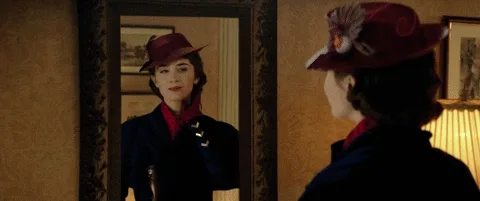 Speaking in Public: How to Use the Power of the Pause for Memorable Talks 7 A woman in hat looking at her reflection on the mirror