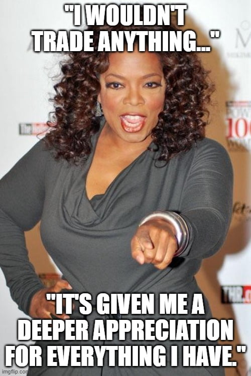 Oprah Winfrey in gray dress showing a pointing gesture