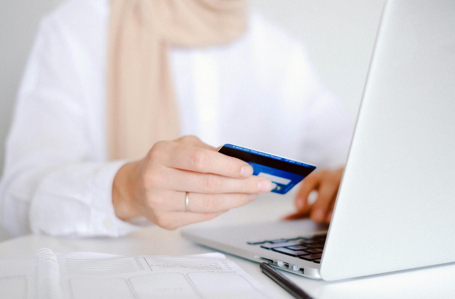 A woman  on her laptop encoding her credit card details for payment