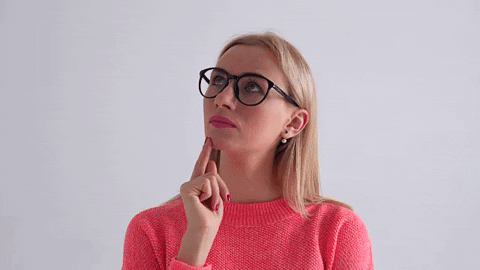 A woman in red top with glasses thinking of an idea